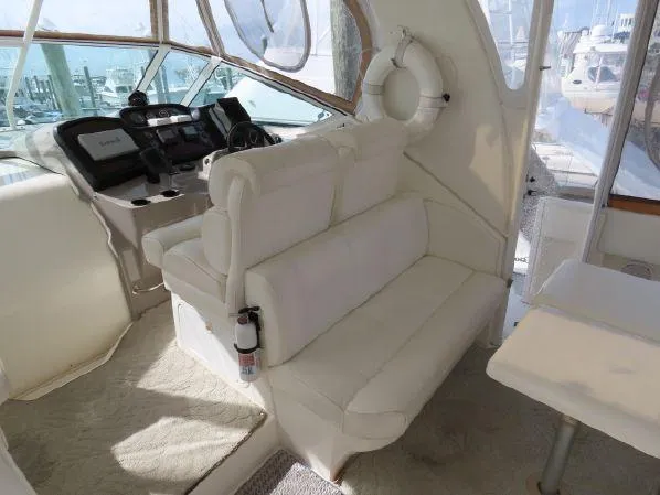 Slide: The Image of 2004 Cruisers Yachts 405 Express Motoryacht interior with white seating and helm station. - 10