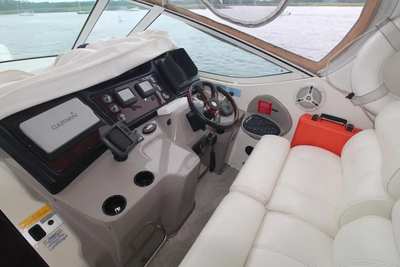 Slide: The Image of 2004 Cruisers Yachts 405 Express Motoryacht cockpit with white seating and navigation equipment. - 13