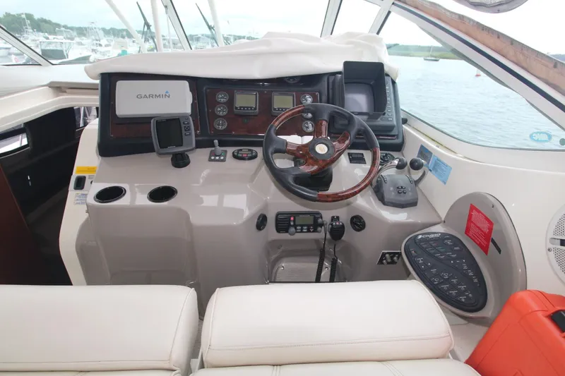 Slide: The Image of 2004 Cruisers Yachts 405 Express Motoryacht helm with navigation equipment and steering wheel. - 15