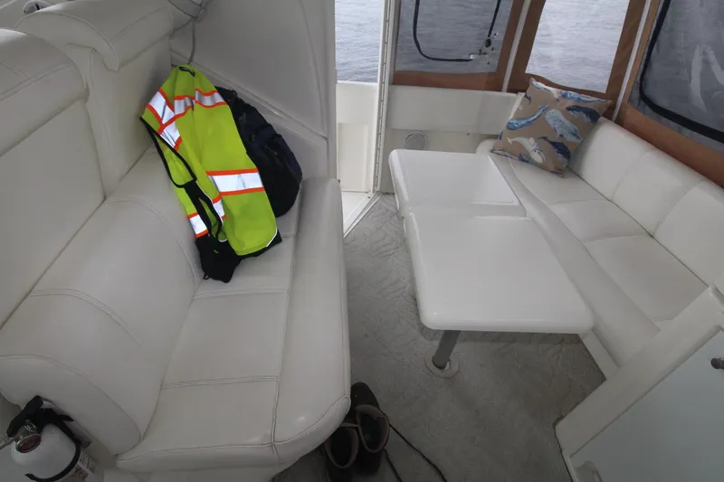 Slide: The Image of 2004 Cruisers Yachts 405 Express Motoryacht interior with white seating and table. - 17