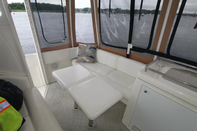 Slide: The Image of 2004 Cruisers Yachts 405 Express Motoryacht interior with white seating and lake view. - 18
