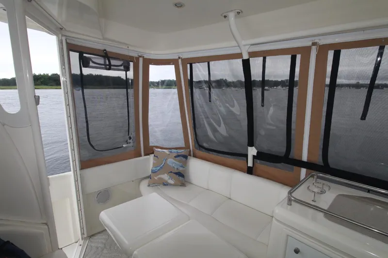 Slide: The Image of 2004 Cruisers Yachts 405 Express Motoryacht interior with white seating and lake view. - 19