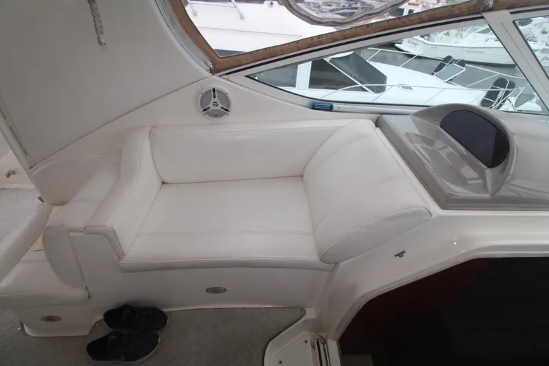 Slide: The Image of 2004 Cruisers Yachts 405 Express Motoryacht interior with white seating and window view. - 23