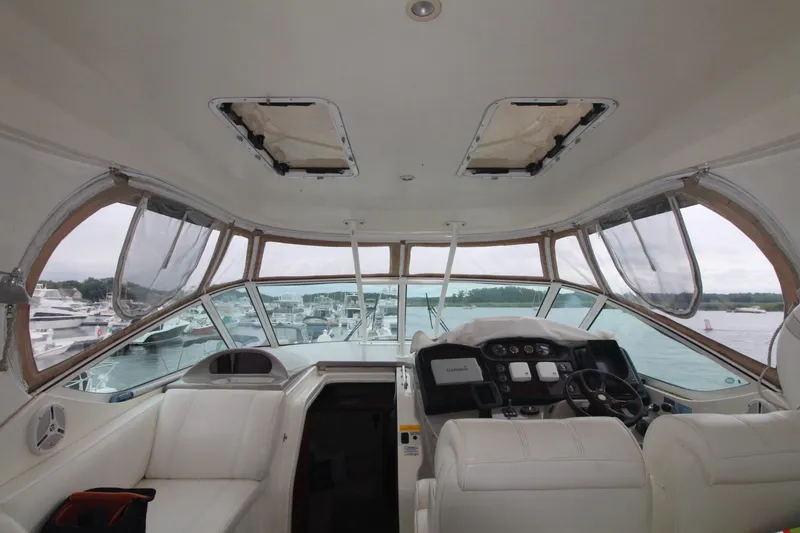 Slide: The Image of Interior view of 2004 Cruisers Yachts 405 Express Motoryacht cockpit with white seating. - 24