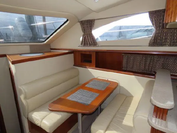 Slide: The Image of Interior of 2004 Cruisers Yachts 405 Express Motoryacht with dining area and seating. - 29