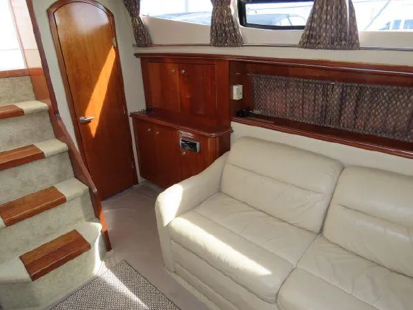 Slide: The Image of Interior of 2004 Cruisers Yachts 405 Express Motoryacht with sofa and wooden cabinetry. - 32