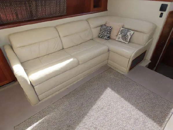 Slide: The Image of Luxurious beige leather sofa in 2004 Cruisers Yachts 405 Express Motoryacht interior. - 34