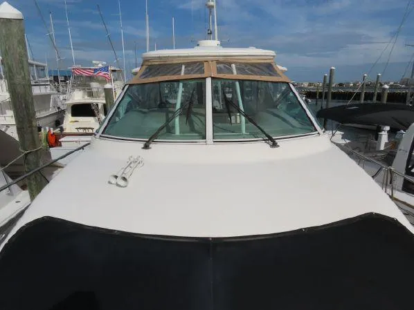 Slide: The Image of 2004 Cruisers Yachts 405 Express Motoryacht docked at marina, front view. - 4