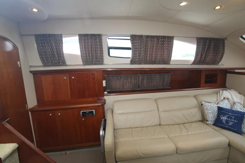 Slide: The Image of Interior of 2004 Cruisers Yachts 405 Express Motoryacht with beige sofa and wooden cabinetry. - 42