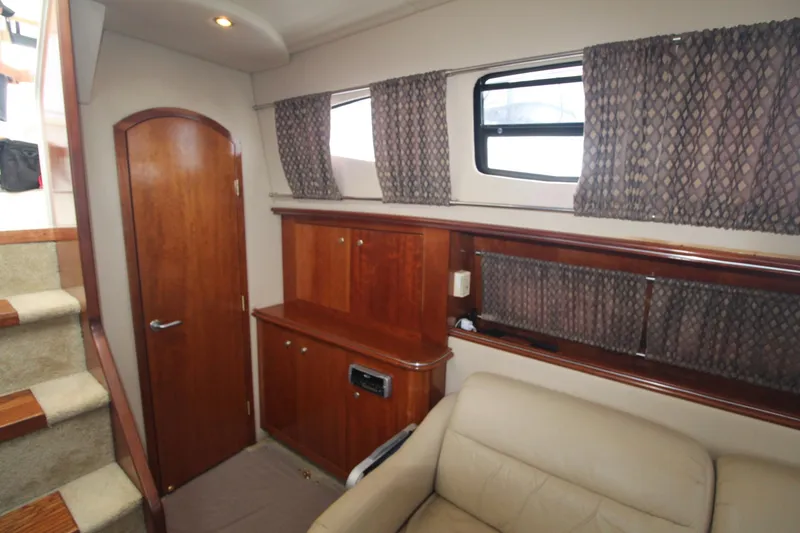 Slide: The Image of Interior of 2004 Cruisers Yachts 405 Express Motoryacht with wood cabinetry and beige seating. - 43