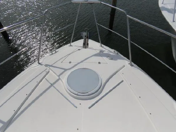 Slide: The Image of Bow of 2004 Cruisers Yachts 405 Express Motoryacht with railing and hatch. - 6