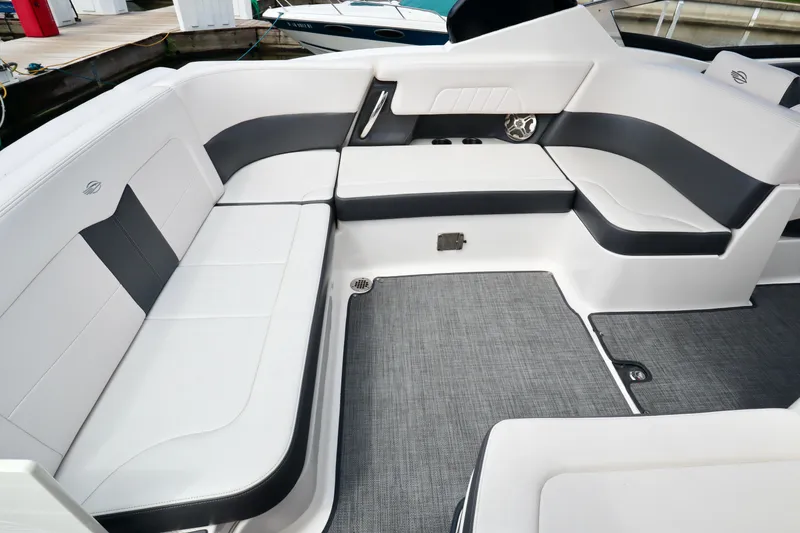 Slide: The Image of 2016 Chaparral 307 SSX boat interior with white and gray seating and carpeted floor. - 10