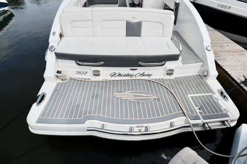 Slide: The Image of 2016 Chaparral 307 SSX boat with "Whiskey Away" name, docked at marina. - 11