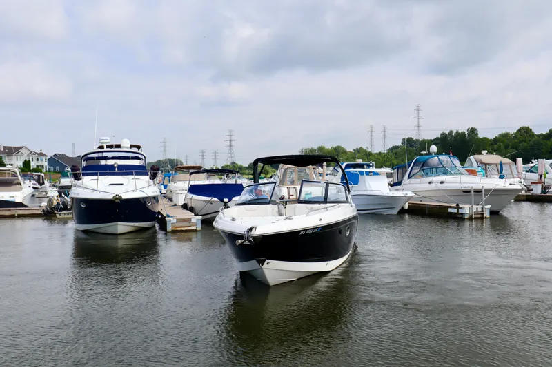 Slide: The Image of 2016 Chaparral 307 SSX boat docked among other vessels in a marina. - 18