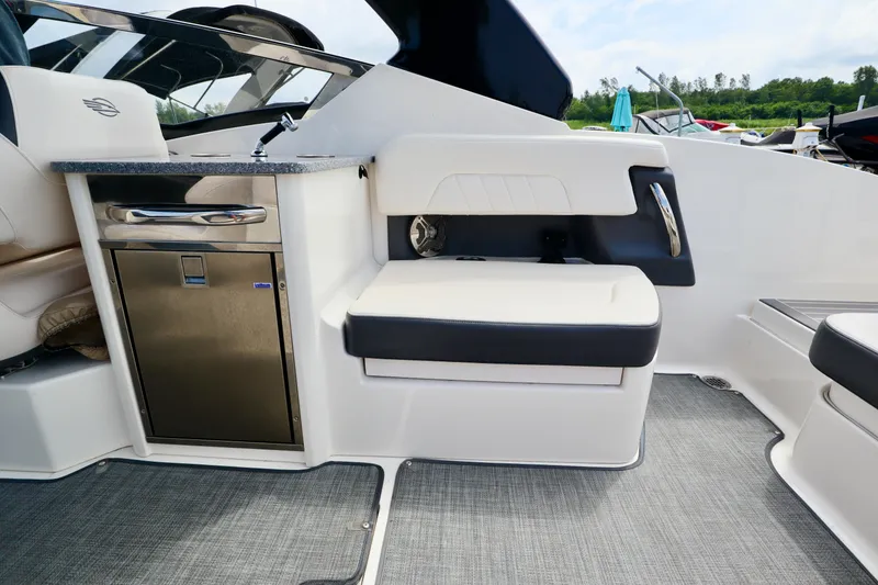 Slide: The Image of Interior of 2016 Chaparral 307 SSX boat with seating and kitchenette area. - 26