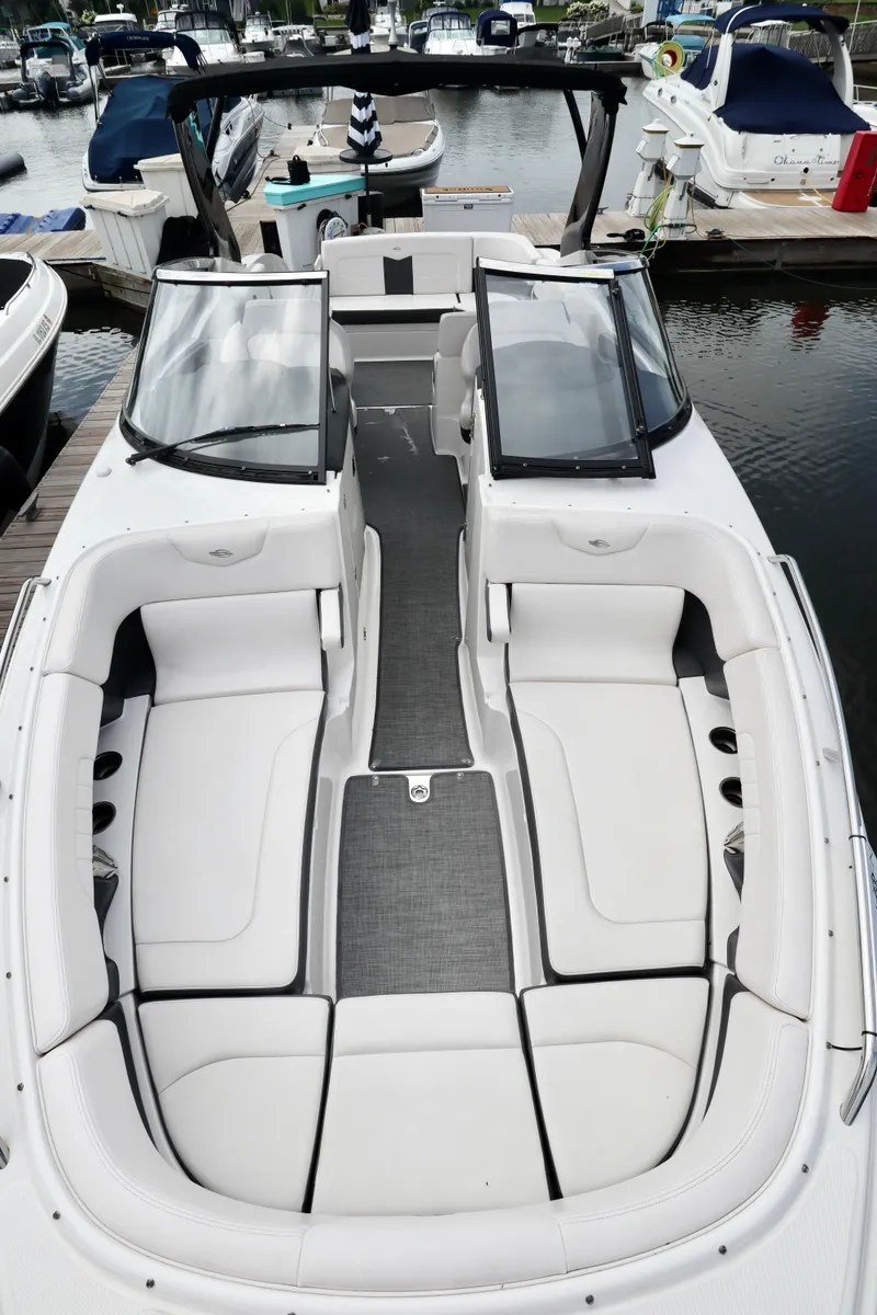 Slide: The Image of 2016 Chaparral 307 SSX boat with spacious seating at a marina. - 29
