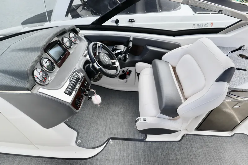 Slide: The Image of 2016 Chaparral 307 SSX boat cockpit with modern dashboard and comfortable seating. - 3