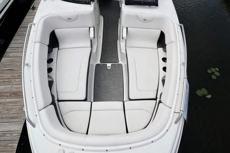 Slide: The Image of 2016 Chaparral 307 SSX boat interior with white seating and gray flooring. - 32