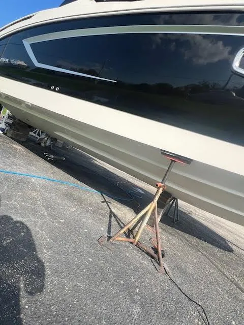 Slide: The Image of 2016 Chaparral 307 SSX boat on stand, black and white hull, outdoor setting. - 36