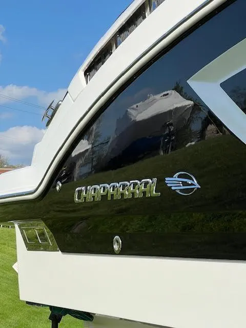 Slide: The Image of 2016 Chaparral 307 SSX boat, sleek black and white design, sunny day background. - 37