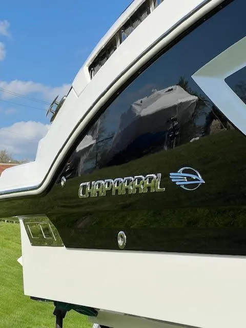Slide: The Image of 2016 Chaparral 307 SSX boat, close-up of logo and sleek black design. - 38