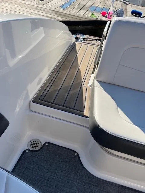 Slide: The Image of 2016 Chaparral 307 SSX boat interior with sleek seating and wooden deck details. - 42