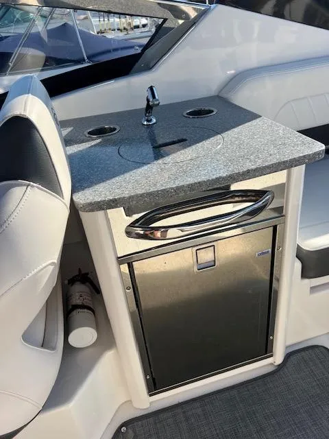 Slide: The Image of 2016 Chaparral 307 SSX boat interior with sink and storage area. - 43
