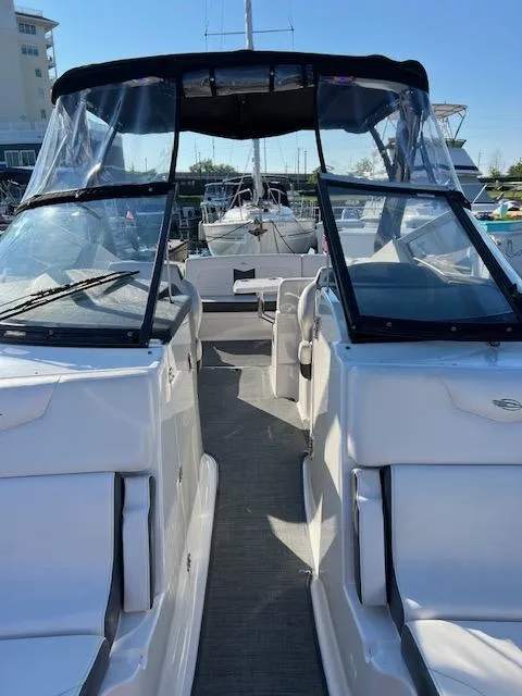 Slide: The Image of 2016 Chaparral 307 SSX boat with open cockpit and clear canopy in marina. - 46