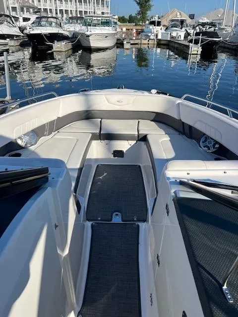 Slide: The Image of 2016 Chaparral 307 SSX boat interior at marina, featuring spacious seating and sleek design. - 47