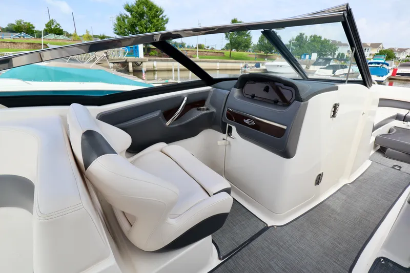 Slide: The Image of 2016 Chaparral 307 SSX boat interior with sleek dashboard and comfortable seating. - 5