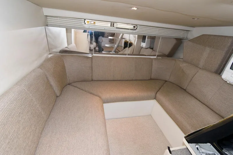 Slide: The Image of 1996 Trojan 350 Express interior with beige seating and mirrored wall. - 13