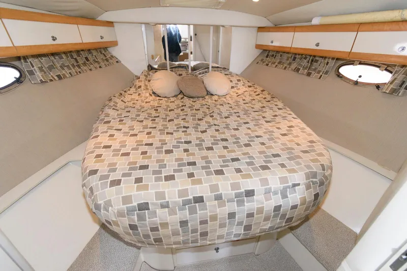 Slide: The Image of 1996 Trojan 350 Express cabin with patterned bedding and cozy interior design. - 14