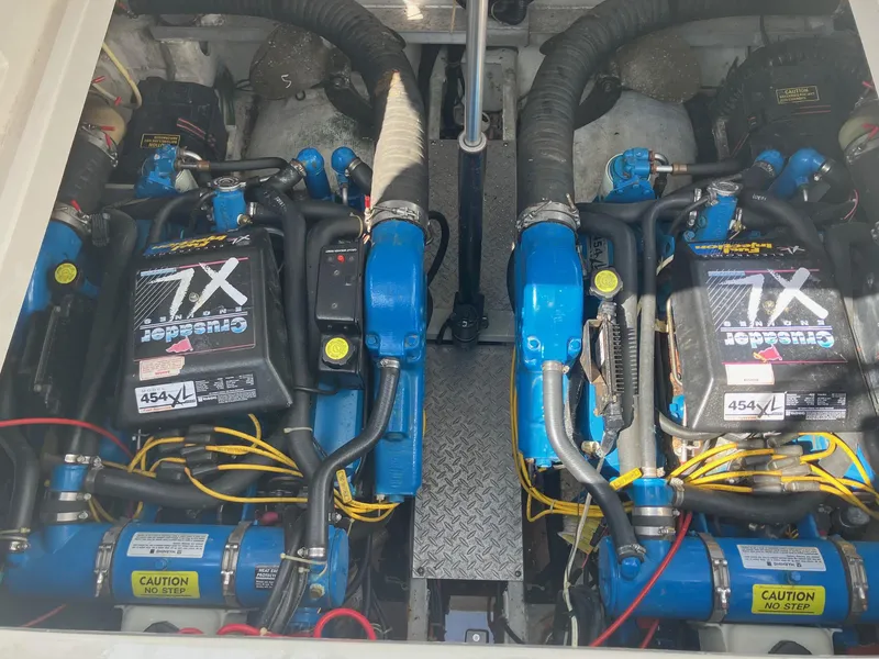 Slide: The Image of Twin engines in a 1996 Trojan 350 Express boat, featuring blue and black components. - 16