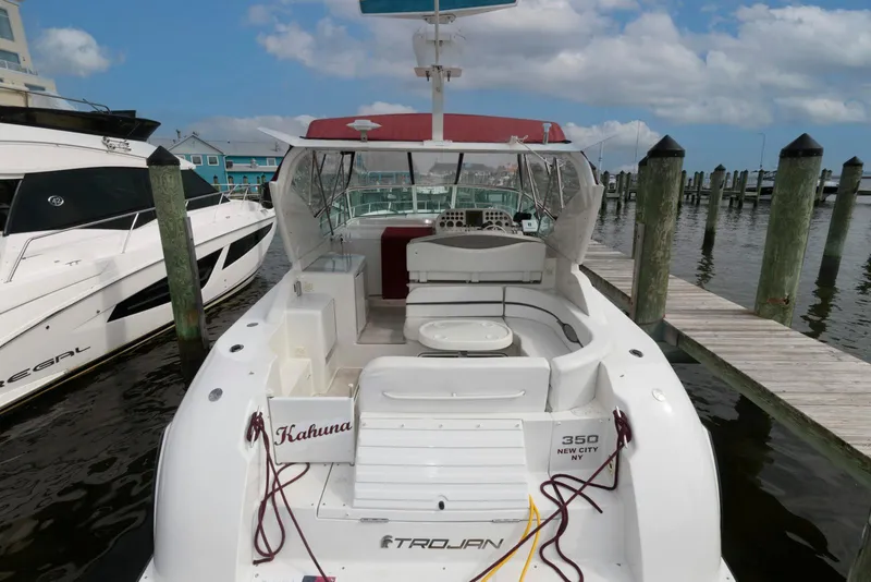 Slide: The Image of 1996 Trojan 350 Express boat docked at marina under blue sky. - 3