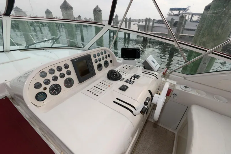 Slide: The Image of 1996 Trojan 350 Express boat cockpit with control panel and gauges at marina. - 8