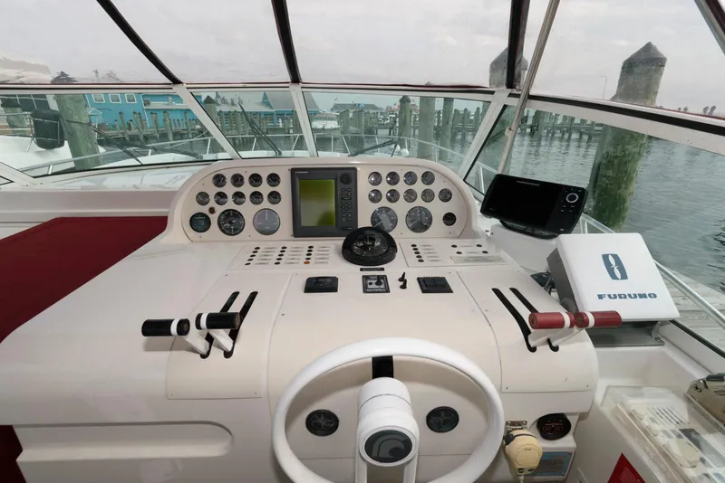 Slide: The Image of Cockpit of a 1996 Trojan 350 Express boat with navigation instruments and controls. - 9