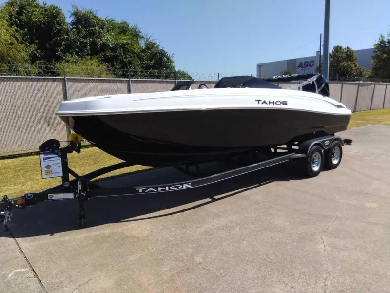 Slide: The Image of 2024 Tahoe T21 boat on a trailer in a parking lot. - 1