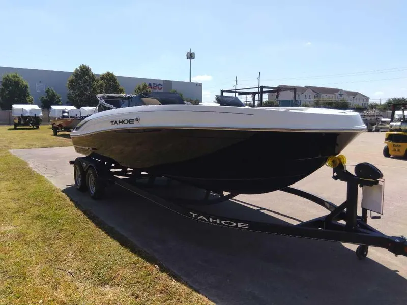 Slide: The Image of 2024 Tahoe T21 boat on trailer in outdoor setting. - 2