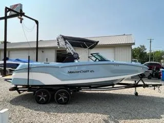 Slide: The Image of 2023 MasterCraft NXT22 boat on a trailer outside a storage facility. - 4