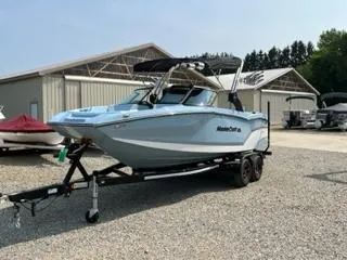 Slide: The Image of 2023 MasterCraft NXT22 boat on a trailer in a boatyard. - 5