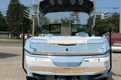 Slide: The Image of 2023 MasterCraft NXT22 boat, rear view, light blue with white and wood accents. - 6