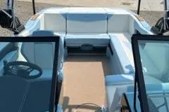 Slide: The Image of 2023 MasterCraft NXT22 boat interior with white seating and dual windshields. - 9