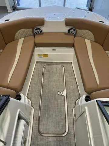 Slide: The Image of 2024 NauticStar 203 DC boat interior with tan seating and storage compartments. - 10