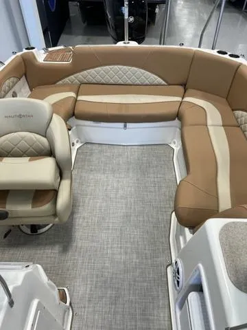 Slide: The Image of 2024 NauticStar 203 DC boat interior with tan and beige seating. - 11