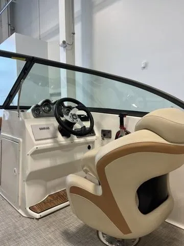 Slide: The Image of 2024 NauticStar 203 DC boat interior with steering wheel and captain's chair. - 12