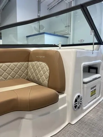 Slide: The Image of 2024 NauticStar 203 DC boat interior with tan quilted seating and Igloo cooler. - 16