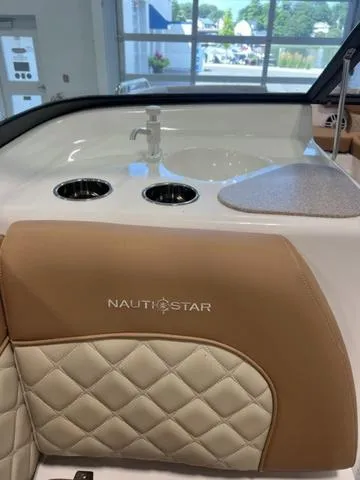 Slide: The Image of NauticStar 203 DC 2024 model interior with sink and cup holders. - 17