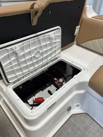 Slide: The Image of 2024 NauticStar 203 DC boat battery compartment with open hatch. - 19