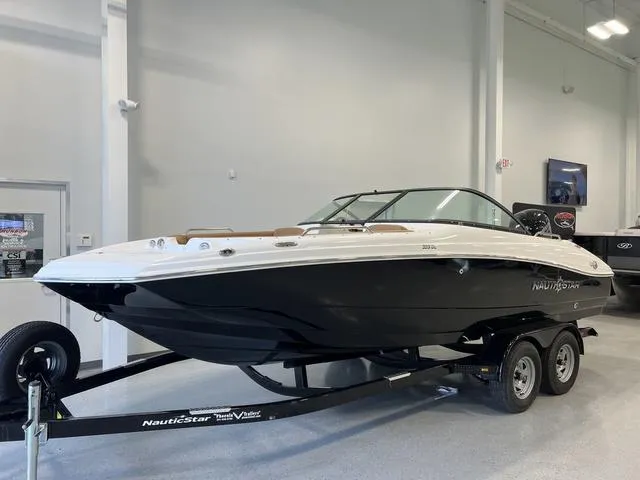 Slide: The Image of 2024 NauticStar 203 DC boat on trailer in showroom. - 2