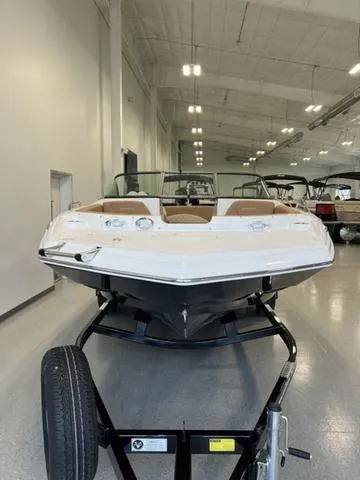 Slide: The Image of 2024 NauticStar 203 DC boat on trailer in showroom. - 3